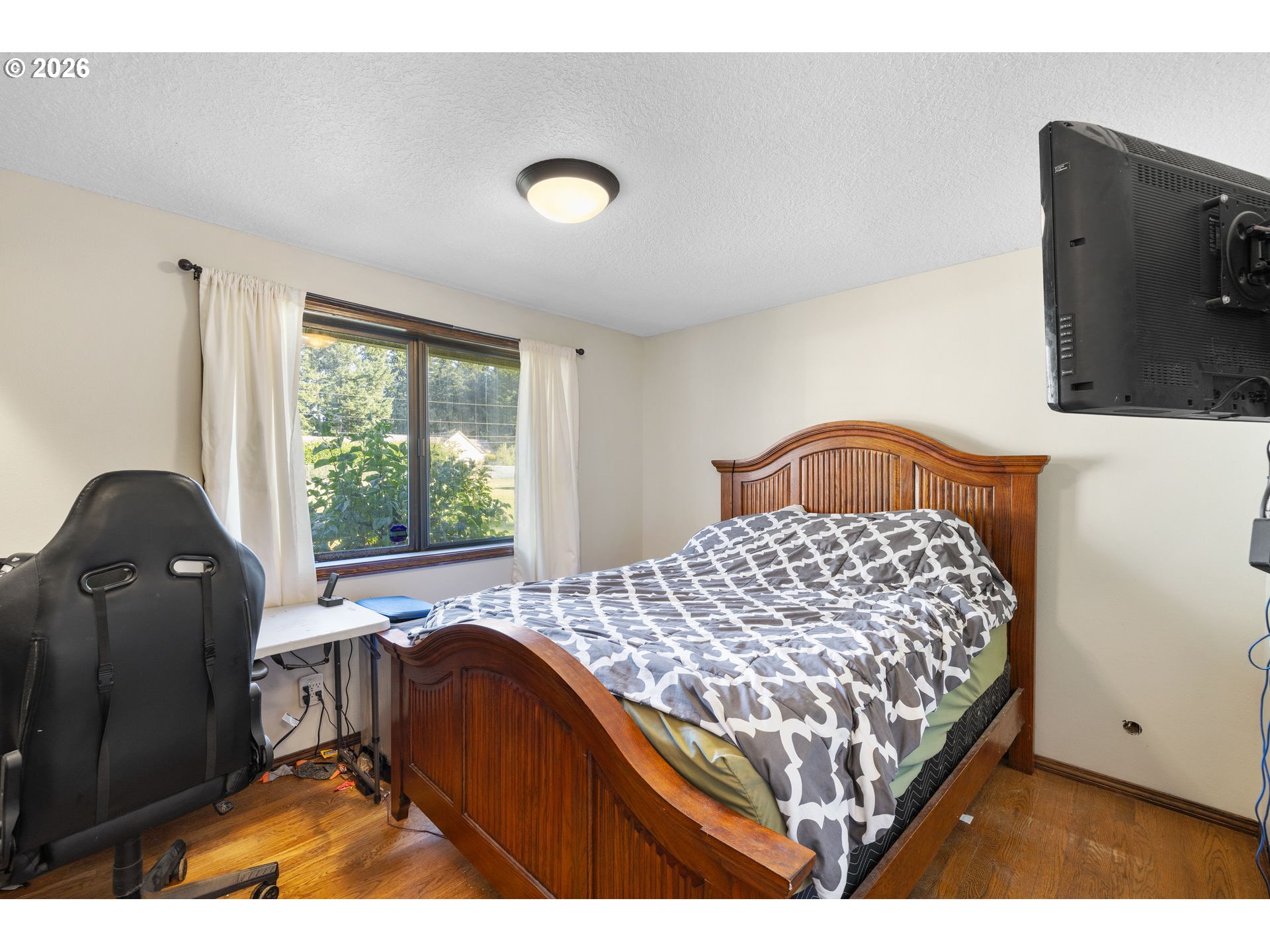 18489 South Ferguson Road Oregon City, OR 97045 - Photo 12 of 39 a bedroom with a bed and a large window