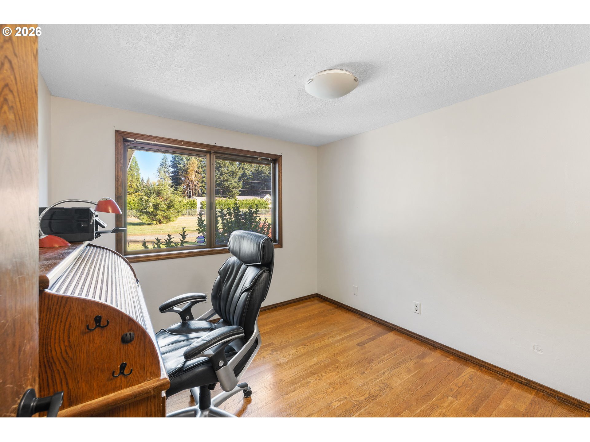 18489 South Ferguson Road Oregon City, OR 97045 - Photo 16 of 39 a view of a workspace with furniture and a window