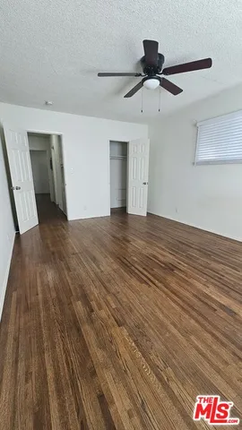 a room with wooden floor and closet