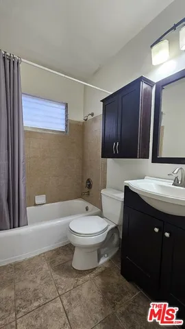 a bathroom with a sink a toilet and bathtub