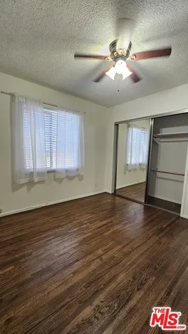 a view of bedroom with furniture and wooden floor