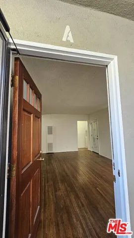 a kitchen with granite countertop a stove a sink and a microwave