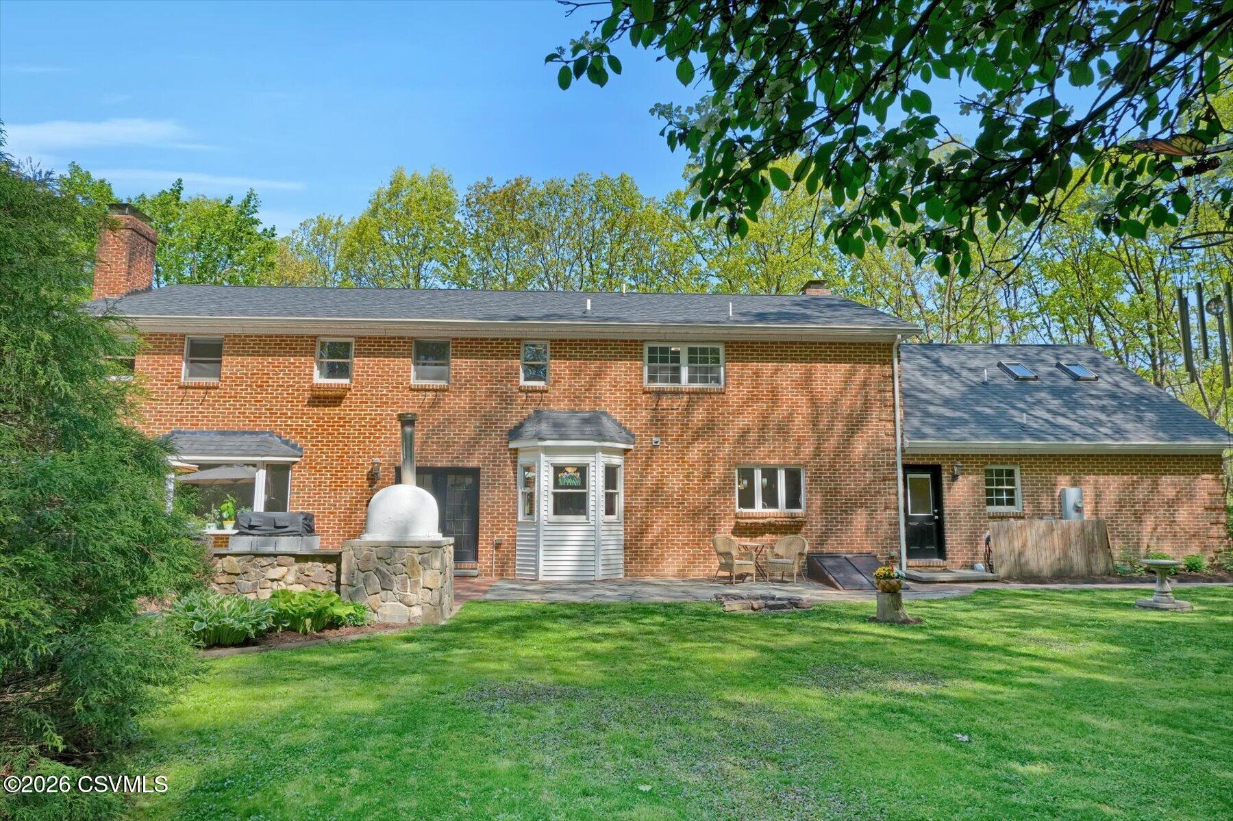 65 Crestview Drive Winfield, PA 17889 - Photo 56 of 70 a front view of a house with a garden and outdoor seating