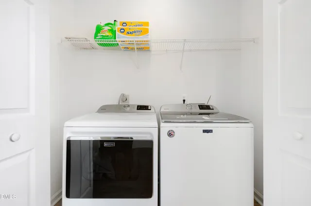 a view of storage and utility room with washer and dryer