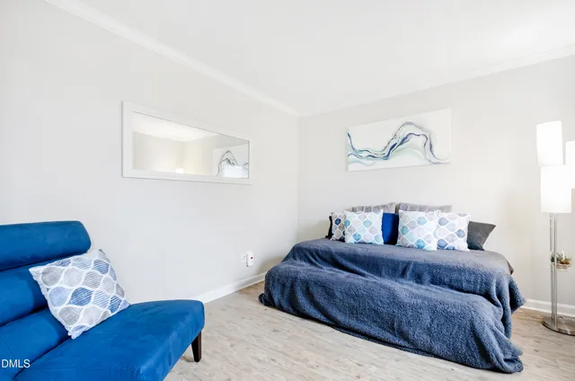 a living room with a couch and painting on the wall