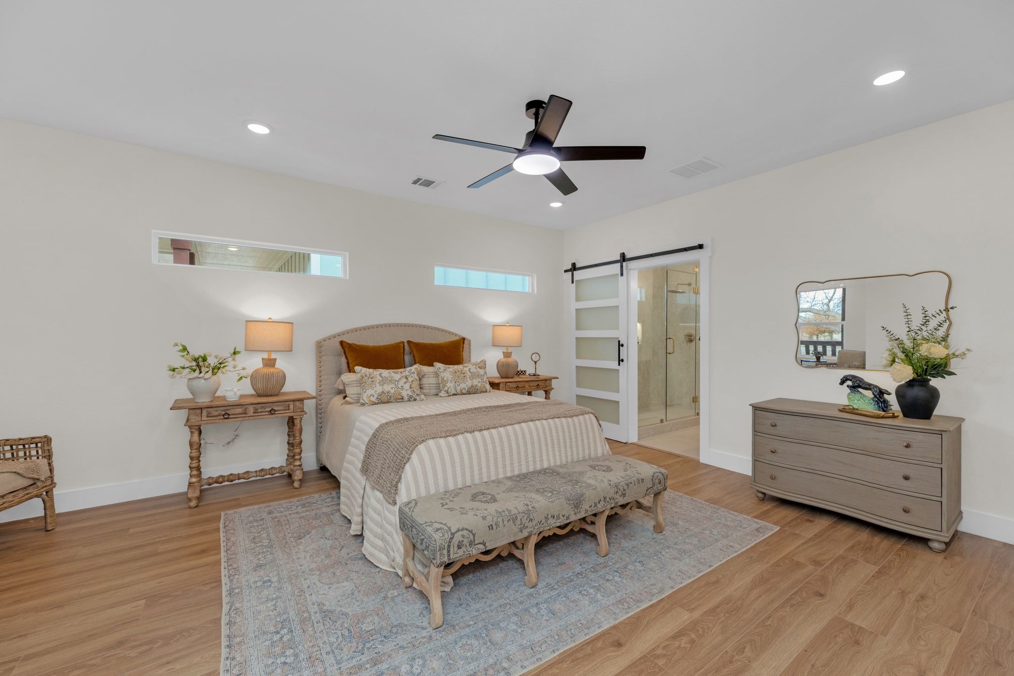 2102 South Church Street Georgetown, TX 78626 - Photo 10 of 40 Bedroom featuring a barn door, a ceiling fan, connected bathroom, and recessed lighting.
Seating area.