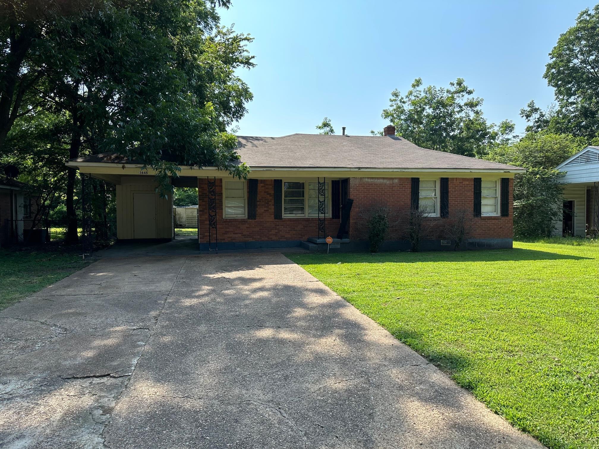 a view of a house with yard and a garden