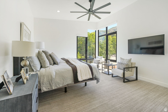 3667 Little Cottonwood Road, Unit 1 Sandy, UT 84092 - Photo 17 of 49 Bedroom featuring expansive windows with mountain and tree scenery, modern ceiling fan, recessed lighting, and light-toned carpeting