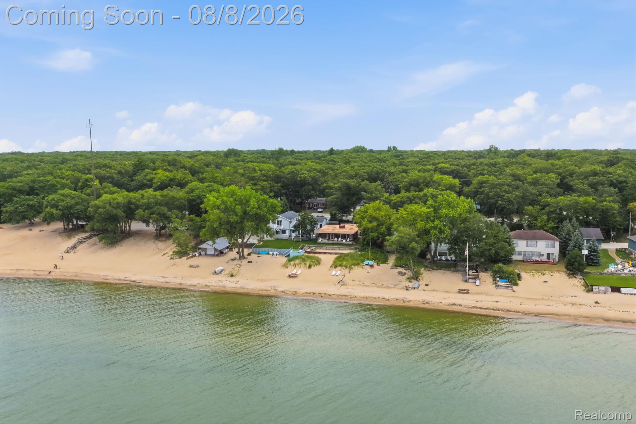 4599 Port Austin Road Caseville, MI 48725 - Photo 37 of 40 Lakeside property with a sand beach frontage, mature trees, and a developed green space