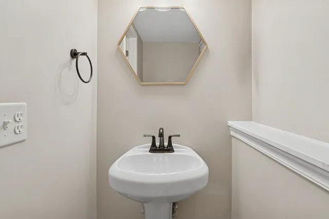 a bathroom with a sink and mirror