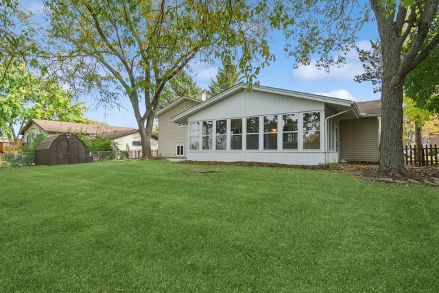 a view of a house with yard and tree s