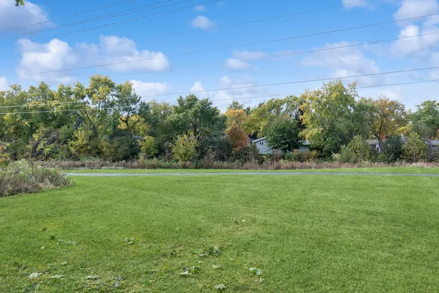a view of field with trees in the background