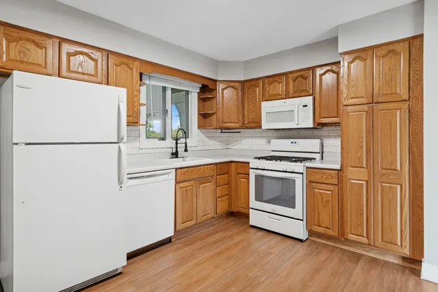 a kitchen with stainless steel appliances a refrigerator sink and cabinets