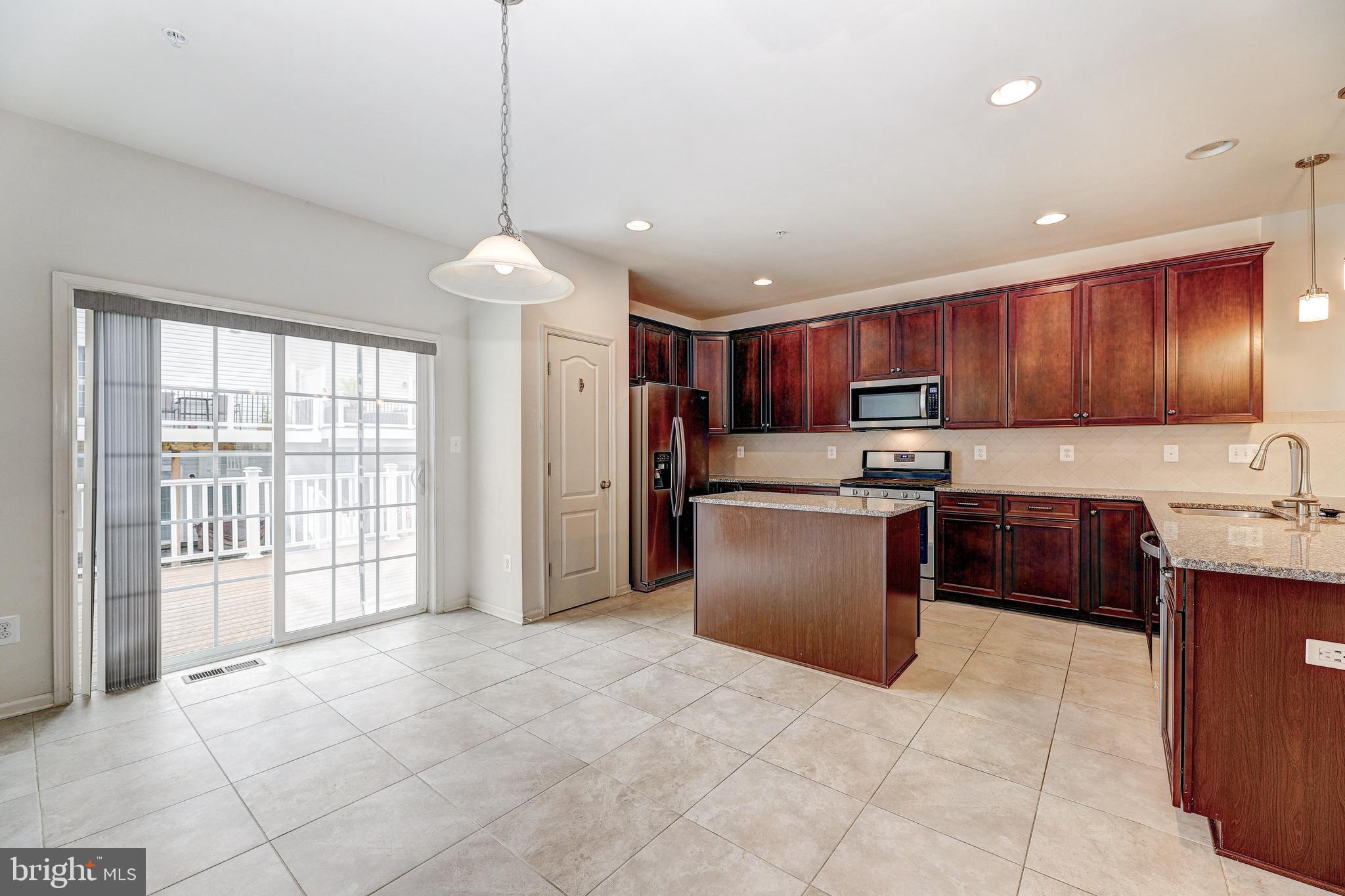 912 Winter Run Road Middle River, MD 21220 - Photo 10 of 55 a kitchen with stainless steel appliances granite countertop a stove top oven a refrigerator a sink and dishwasher