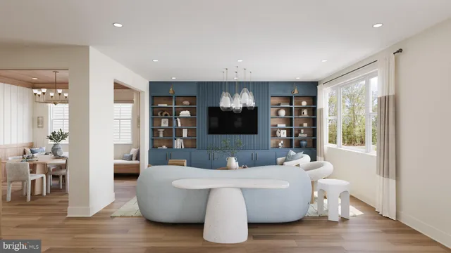a living room with couches and a large mirror with wooden floor