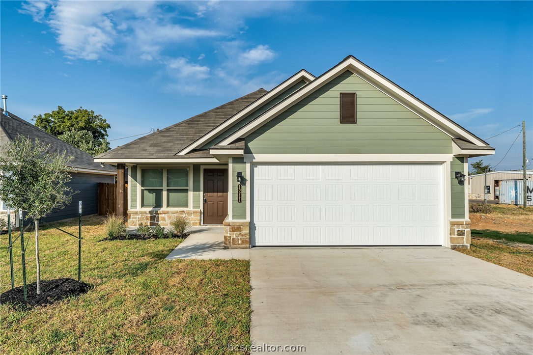 2766 Messenger Way Bryan, TX 77803 - Photo 1 of 12 a front view of a house with garden