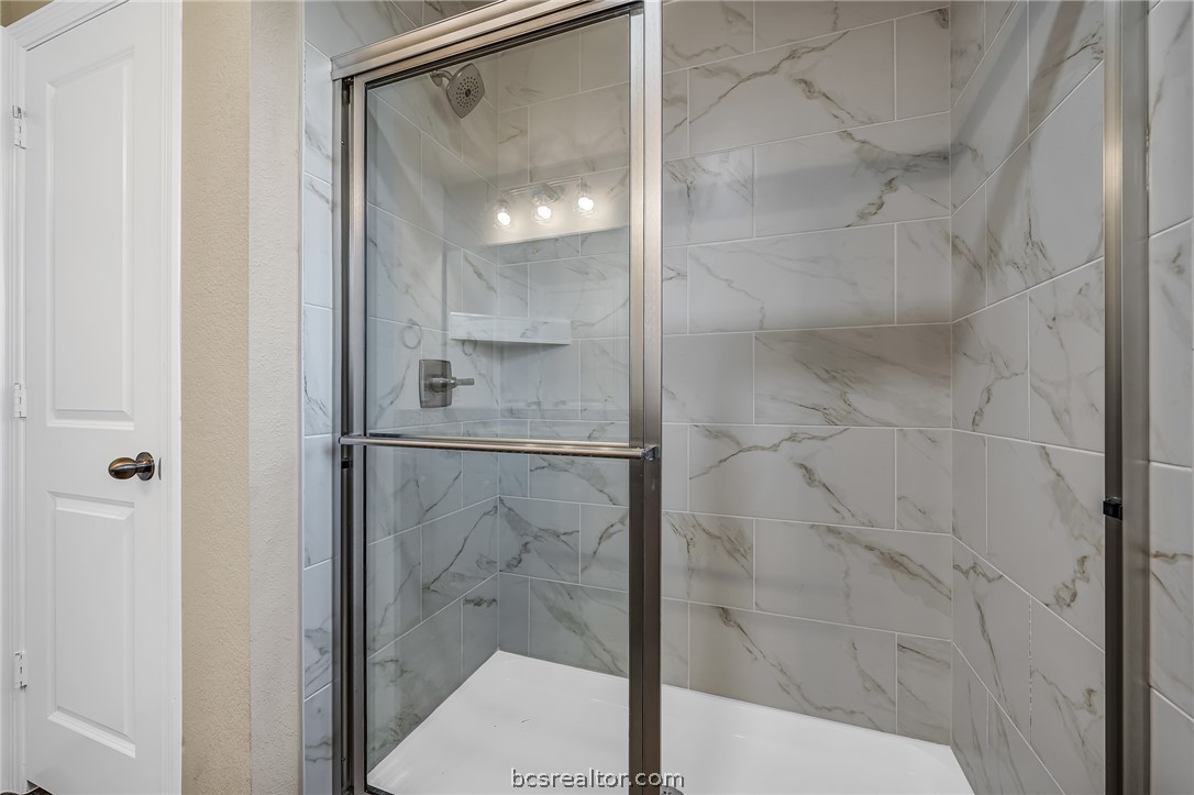 2766 Messenger Way Bryan, TX 77803 - Photo 11 of 12 a bathroom with a glass shower door