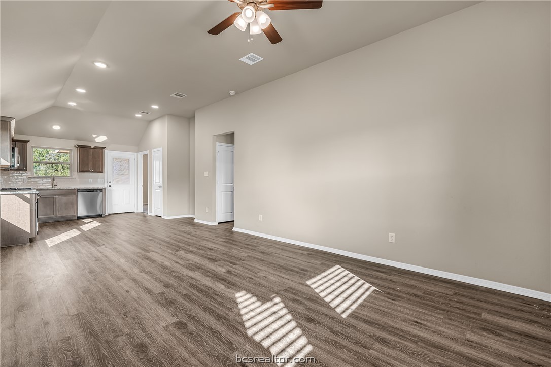 2766 Messenger Way Bryan, TX 77803 - Photo 3 of 12 a view of kitchen and empty room with wooden floor