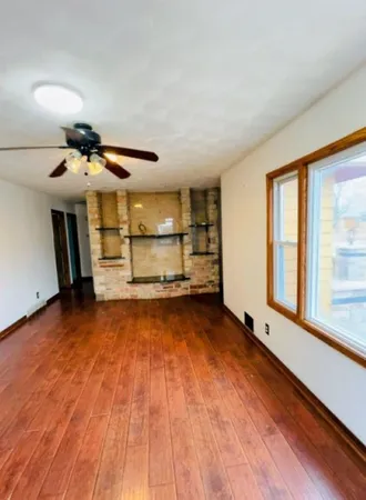 a view of a room with wooden floor and windows