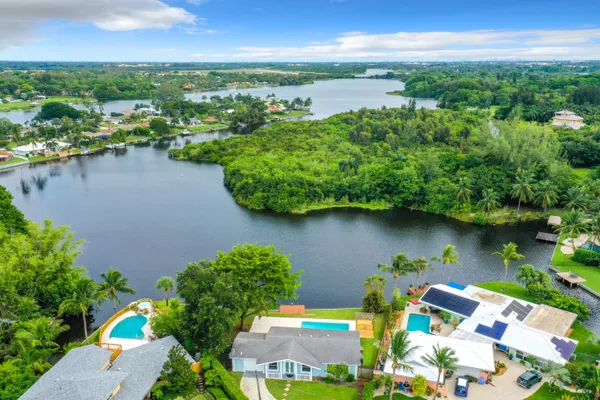an aerial view of lake and residential houses with outdoor space