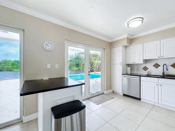 a kitchen with a stove a sink and a refrigerator
