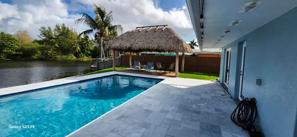 a view of a backyard with swimming pool