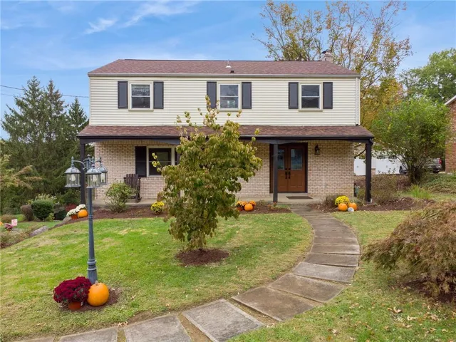 a view of a house with backyard and sitting area