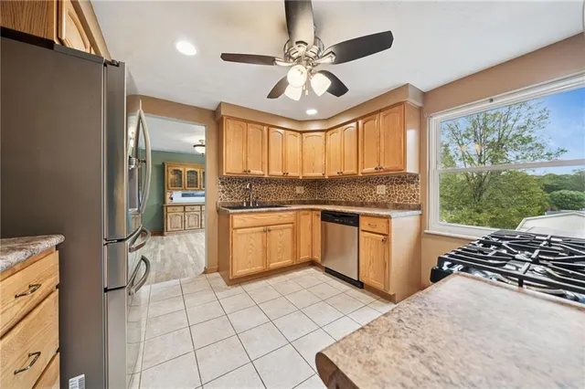 a kitchen with a stove a sink and a refrigerator