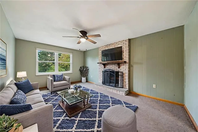 a living room with furniture a fireplace and a flat screen tv