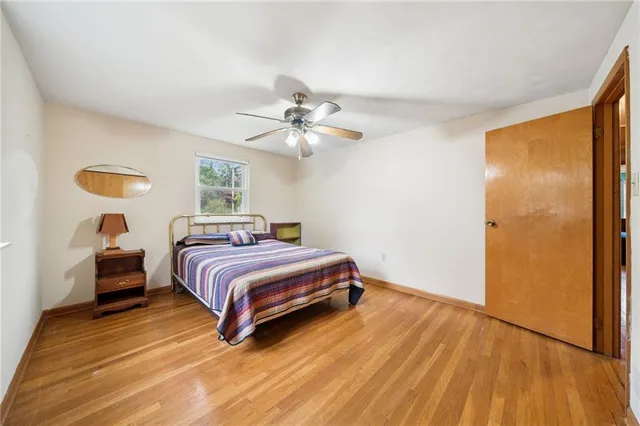 a spacious bedroom with a bed and a chandelier