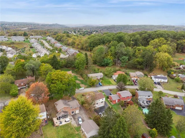 an aerial view of a houses with a lake view