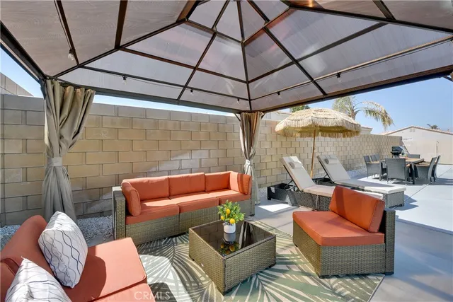 a outdoor living space with furniture and umbrella