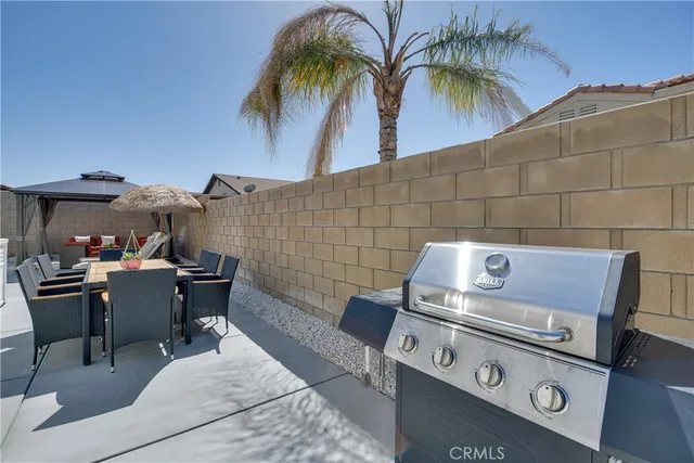 a view of a dinning table and chairs in patio