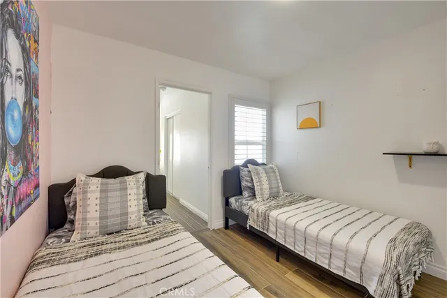 a bedroom with a bed lamp and window