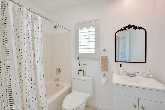 a bathroom with a sink toilet a shower and a mirror