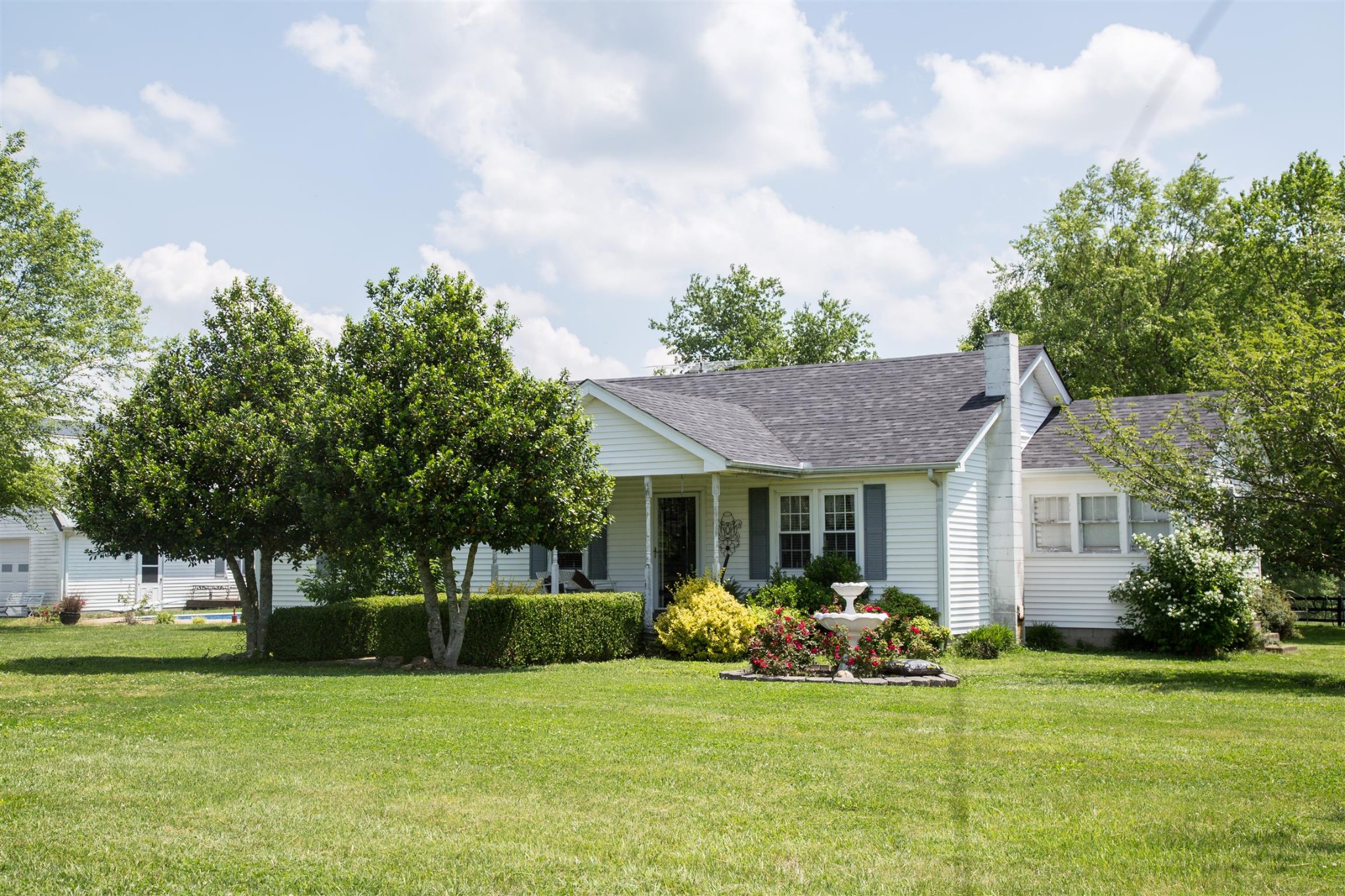a view of a house with a yard and sitting area