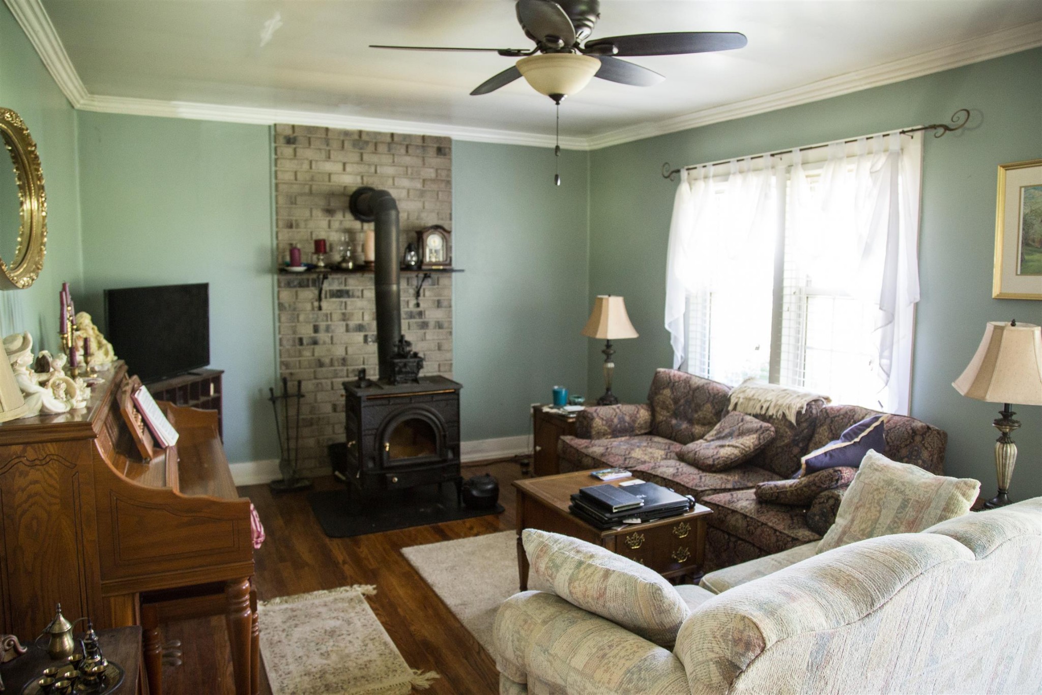 699 Mcelhiney Road Dickson, TN 37055 - Photo 6 of 25 a living room with furniture a fireplace and a flat screen tv