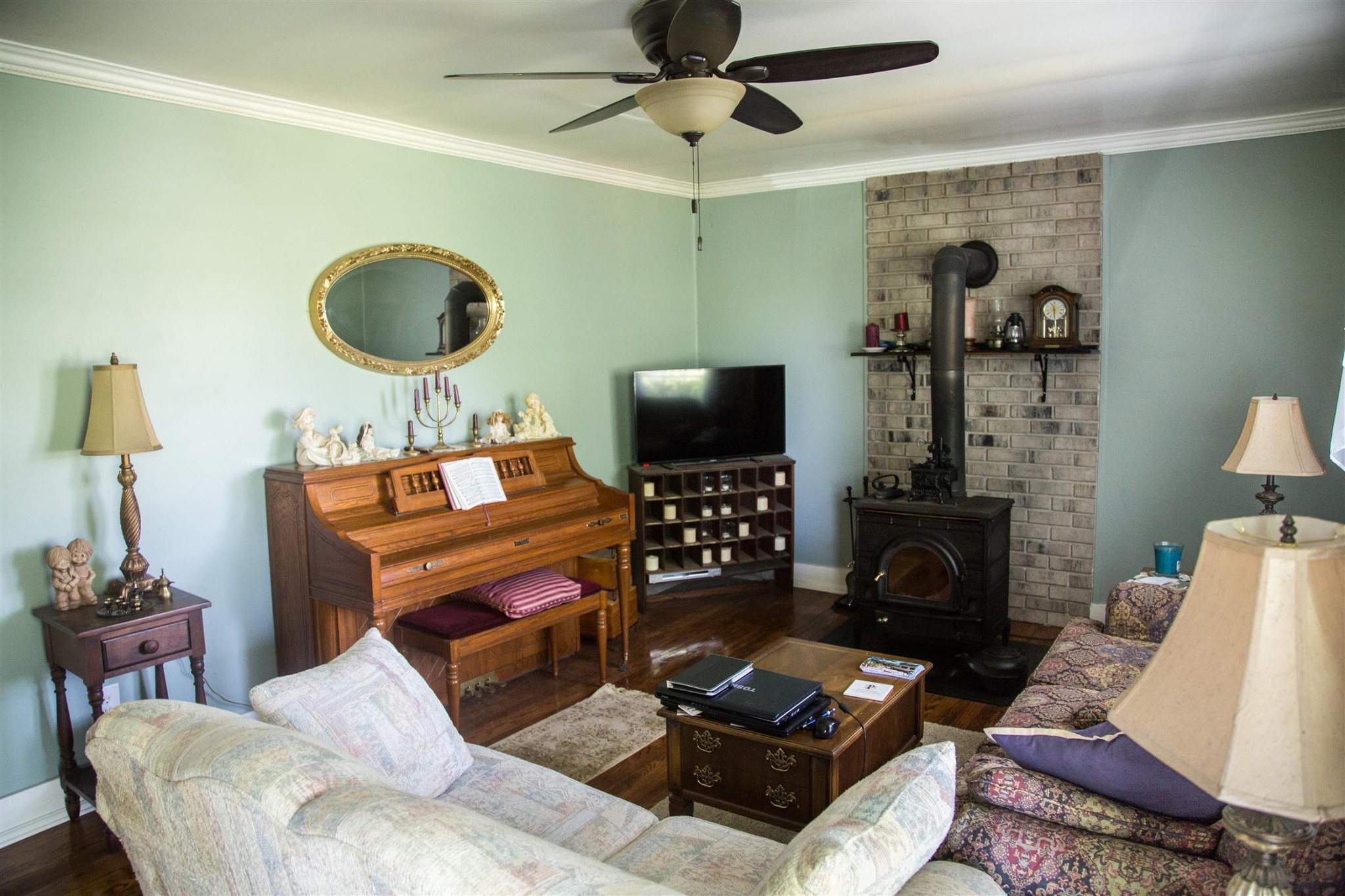 699 Mcelhiney Road Dickson, TN 37055 - Photo 8 of 25 a living room with furniture a flat screen tv and a fireplace