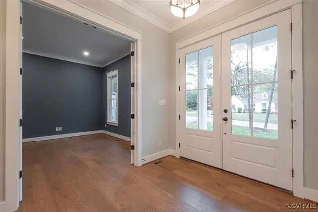 a kitchen with a sink and a stove top oven with wooden floor