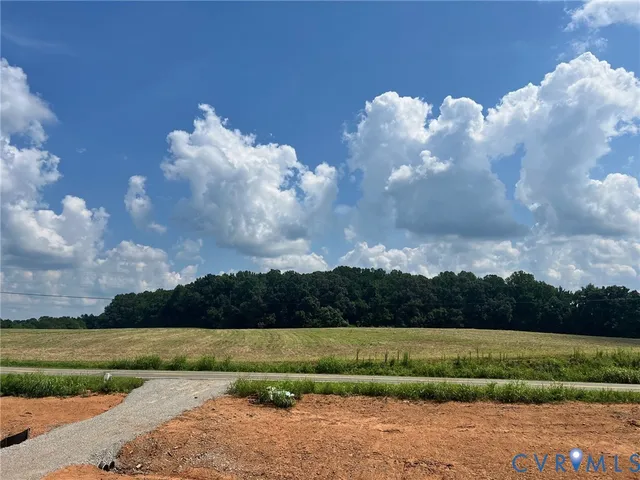 a view of a hallway with wooden floor and entryway