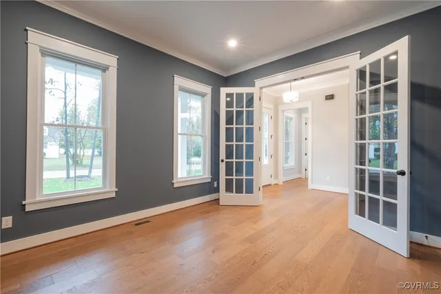 a view of a kitchen with a stove cabinets a ceiling fan and wooden floor