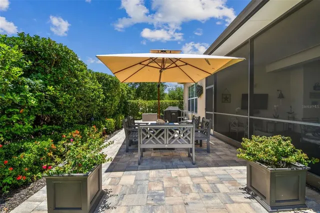 a patio with plants and outdoor seating