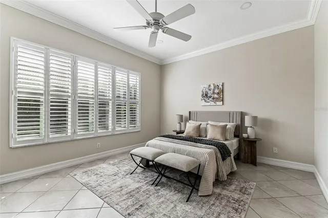 a bed sitting in a bedroom next to a window