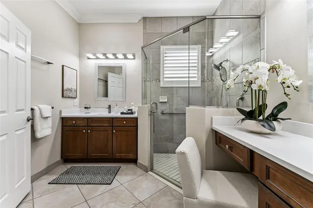 a spacious bathroom with a double vanity sink a mirror and a shower