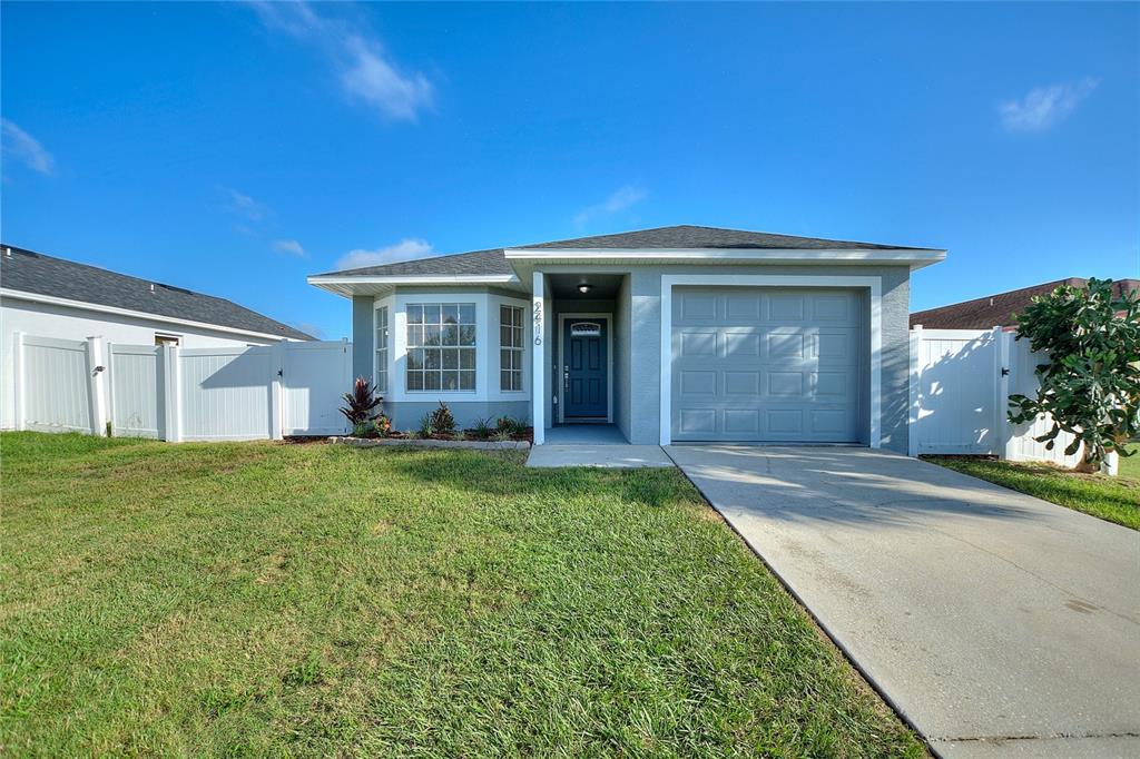 a view of a house with backyard and porch