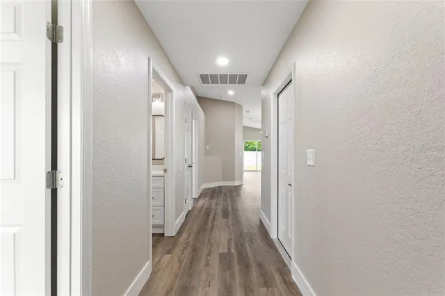 a view of hallway with wooden floor