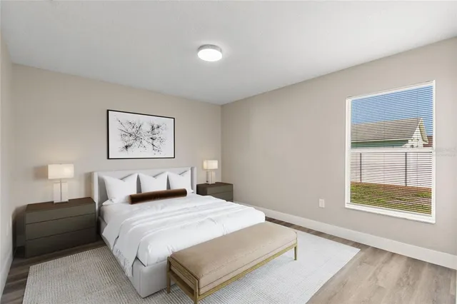 a bedroom with a bed and a window