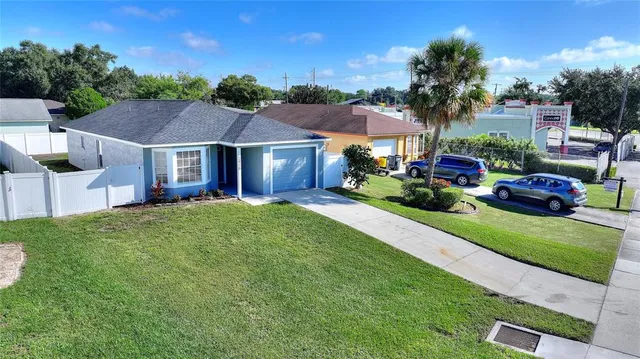 a front view of a house with a garden and plants