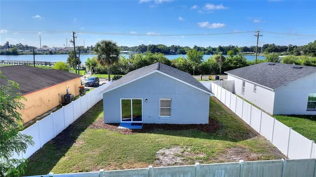 a aerial view of a house next to a yard