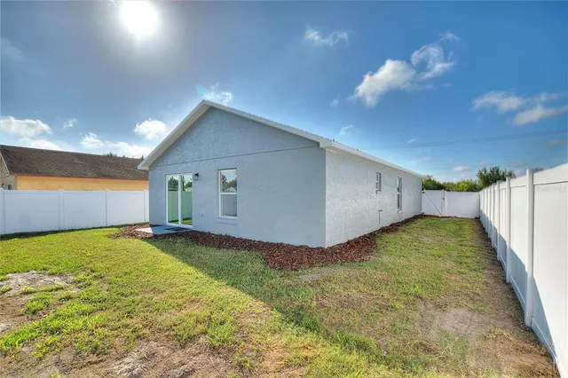 an aerial view of a residential houses with outdoor space and street view